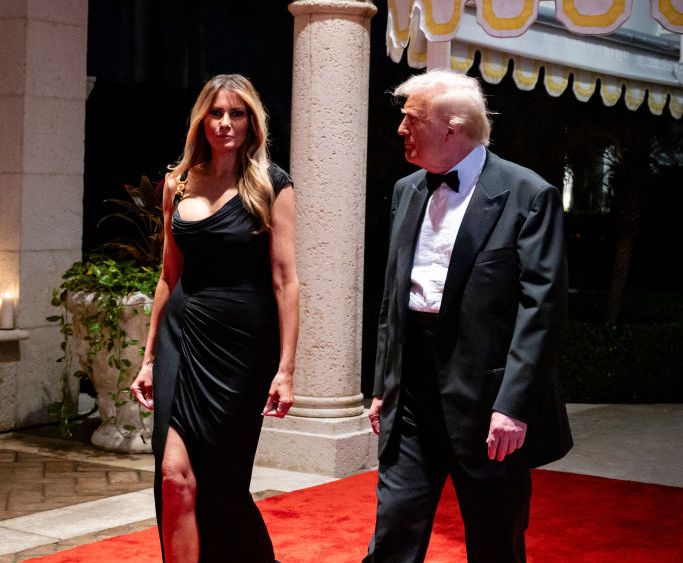 PALM BEACH, FLORIDA - DECEMBER 31:  U.S. President-elect Donald Trump and his wife Melania Trump arrive on New Year's Eve at his Mar-A-Lago Club on December 31, 2024 in Palm Beach, Florida. Trump continues to fill posts in his upcoming administration ahead of his January 20 inauguration. (Photo by Eva Marie Uzcategui/Getty Images)