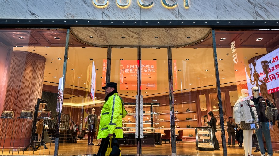 A illuminated storefront of a Gucci store in Chongqing.