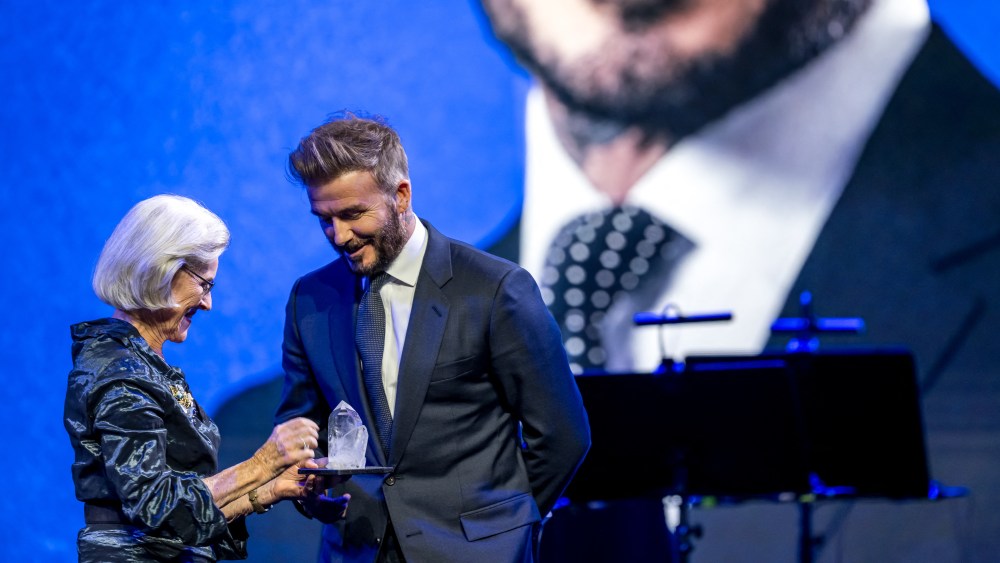 Former England's football player and UNICEF Goodwill Ambassador David Beckham (L) receives his prize from Schwab Foundation for Social Entrepreneurship chairperson Hilde Schwab during the Crystal Award ceremony at the World Economic Forum (WEF) annual meeting in Davos on January 20, 2025. (Photo by Fabrice COFFRINI / AFP) (Photo by FABRICE COFFRINI/AFP via Getty Images)