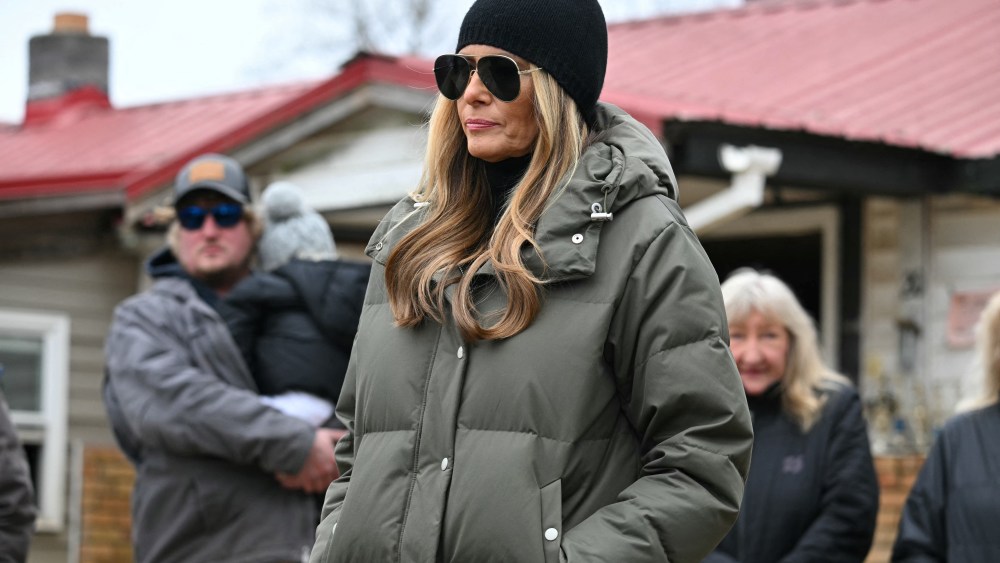 US First Lady Melania Trump and residents listen to US President Donald Trump speak as he surveys recovery efforts in a neighborhood affected by Hurricane Helene in Swannanoa, North Carolina, on January 24, 2025. (Photo by Mandel NGAN / AFP) (Photo by MANDEL NGAN/AFP via Getty Images)