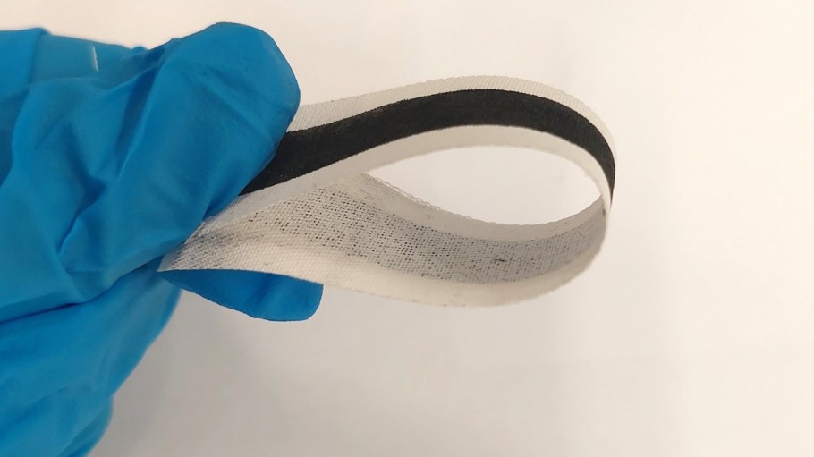 Strip of e-textile demonstrating the flexible qualities of ink jet printed graphene.