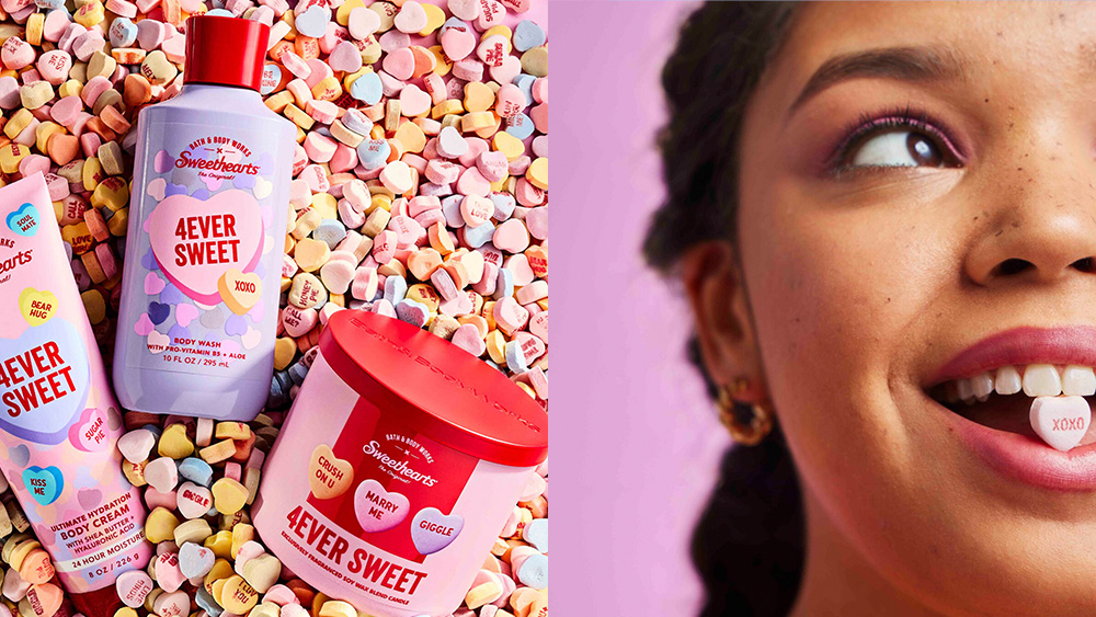 three products from body care company bath & body works arranged on a sea of sweethearts candies; a woman looking off to the side while holding said candy in her mouth