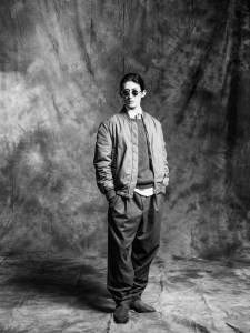 Brunello Cucinelli shirt, tie, bomber jacket, pants, sweater and shoes; Moscot sunglasses.