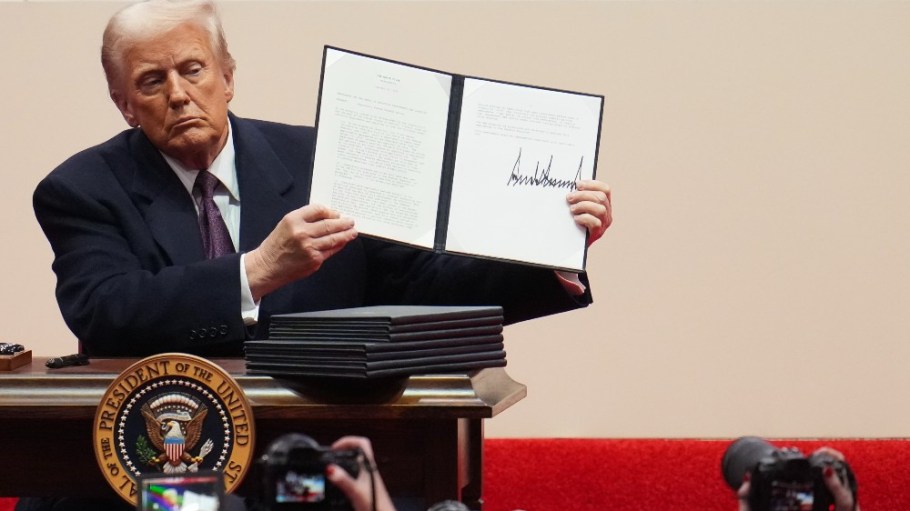 President Donald Trump signs executive orders at Capital One Arena in Washington, D.C. on Monday.