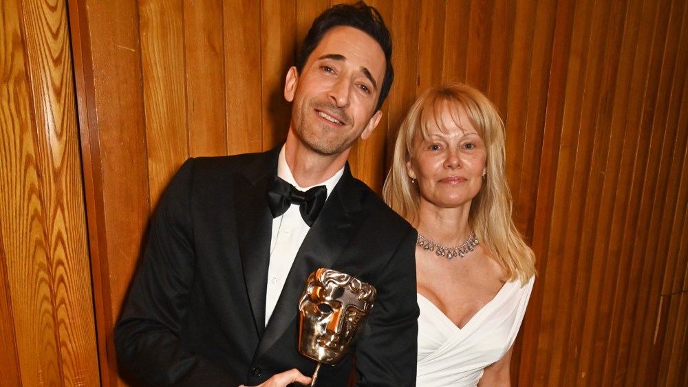 LONDON, ENGLAND - FEBRUARY 16: Adrien Brody, winner of the Best Actor award for "The Brutalist", and Pamela Anderson pose backstage during the EE BAFTA Film Awards 2025 at The Royal Festival Hall on February 16, 2025 in London, England. (Photo by Dave Benett/BAFTA/Getty Images for BAFTA)