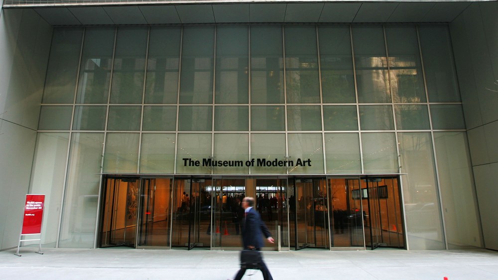A pedestrian walks outside the entrance to the new Museum of Modern Art building on 53rd Street November 17, 2004 in New York City. The new Yoshio Taniguchi-designed building opens to the public November 20.