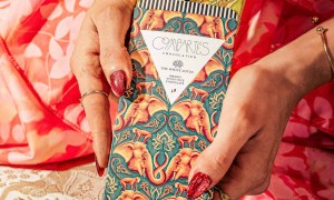 Compartés x The White Lotus chocolate bar held up in someone's manicured hands