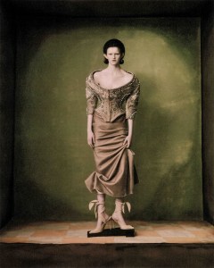 Schiaparelli haute couture off-the-shoulder jacket in stripes of velvet embroidery with rhinestones and pearls, and velvet column skirt. And floral corset canvas heeled sandal with an asymmetrical wavy décolleté.
