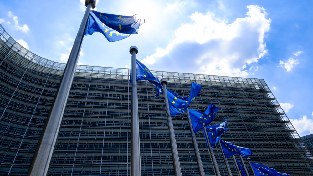 The EU flags flutter in the wind in front of the Berlaymont, the EU Commission headquarter in Brussels, Belgium.