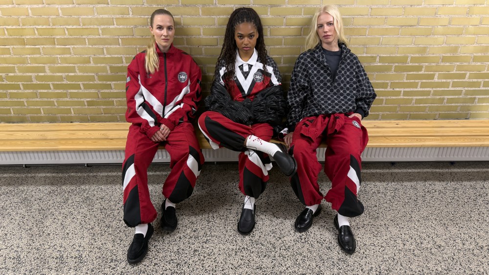 Danish soccer players Sara Thrige, Isabella Obaze, and Sofie Svava wearing pieces from the capsule.