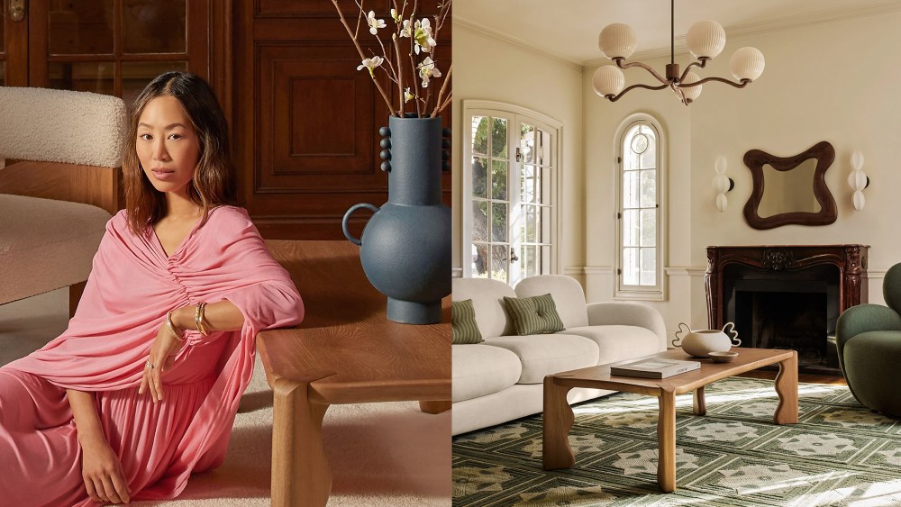 aimee song sits next to a wooden coffee table; living room with sculptural lighting, a bright rug, and a fireplace