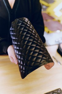 Checking a section of quilted leather at Chanel’s AVH handbag factory.