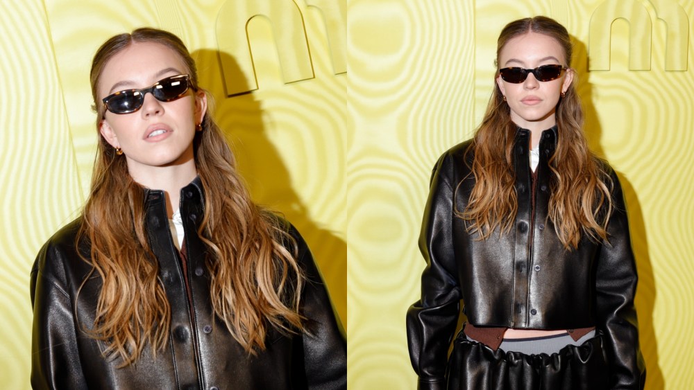 Sydney Sweeney poses for photos ahead of Miu Miu's fall 2025 show during Paris Fashion Week.