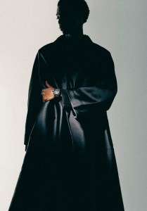 Bell & Ross satin-finished black ceramic watch with 41mm case; Dior blended silk scuba canvas coat and wool twill pants.