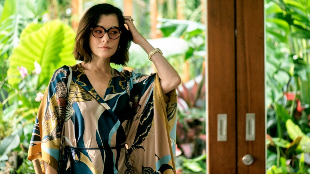 Parker Posey as Victoria Ratliff wearing Jim Thompson's Slipper Orchid silk kimono dress in "The White Lotus."