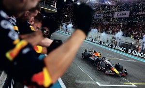 Verstappen takes the checkered flag to win the 2023 Abu Dhabi Grand Prix and his third consecutive drivers’ title.