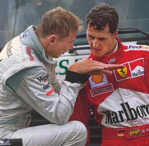 After the 2000 Belgian Grand Prix, Mika Häkkinen demonstrates his winning passing move to Michael Schumacher.