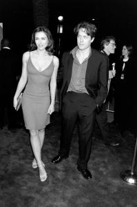 (L-R, foreground) Elizabeth Hurley and Hugh Grant attend the local premiere of "EDtv" at the Universal Amphitheater in Los Angeles, California, on March 16, 1999.
