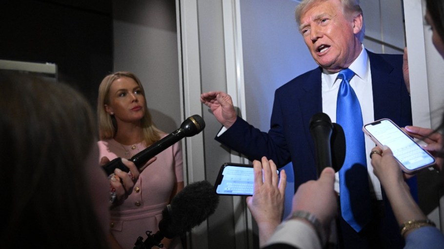 President Donald Trump speaks to reporters aboard Air Force One on Sunday.