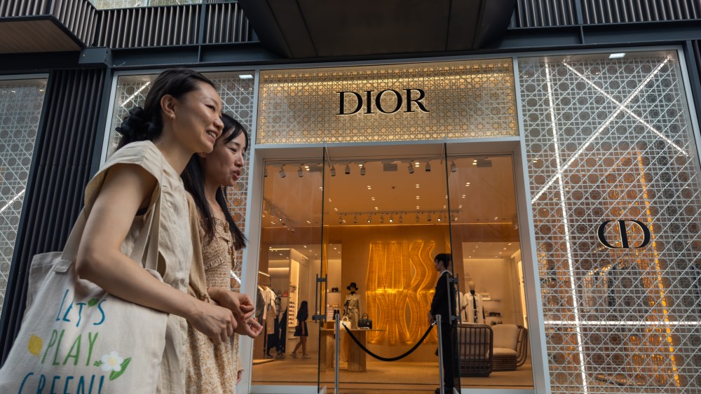Chinese shoppers walk past a Dior store in Chengdu.