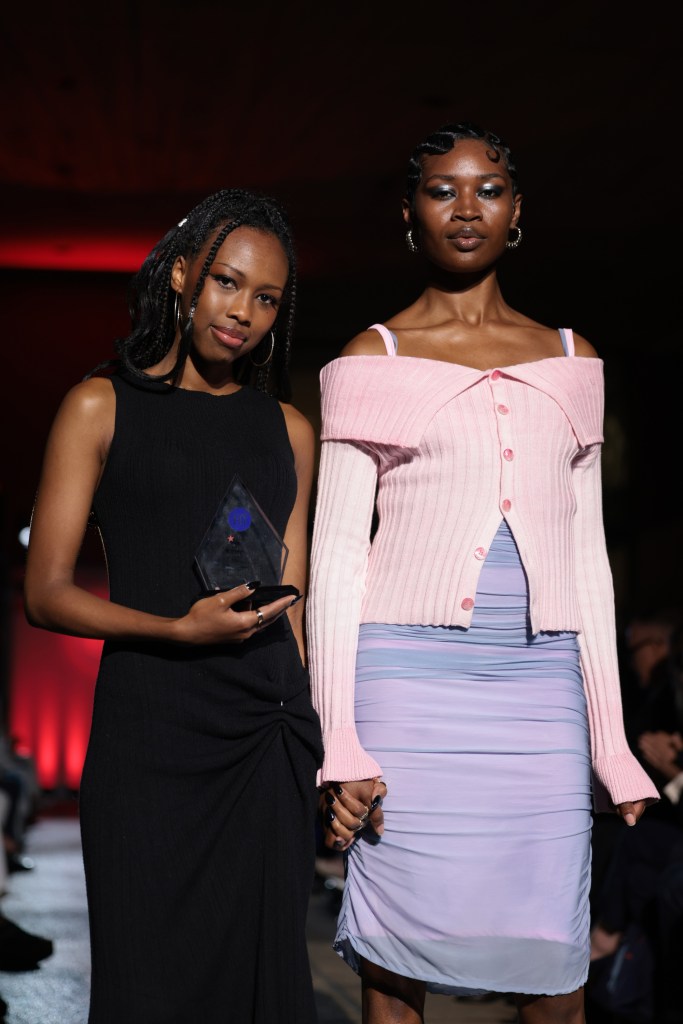 Khoboso Nale walks the 2025 "Future of Fashion" runway at FIT with a model wearing her winning design.