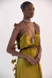 A model wearing the high jewelry lipstick holder necklace.