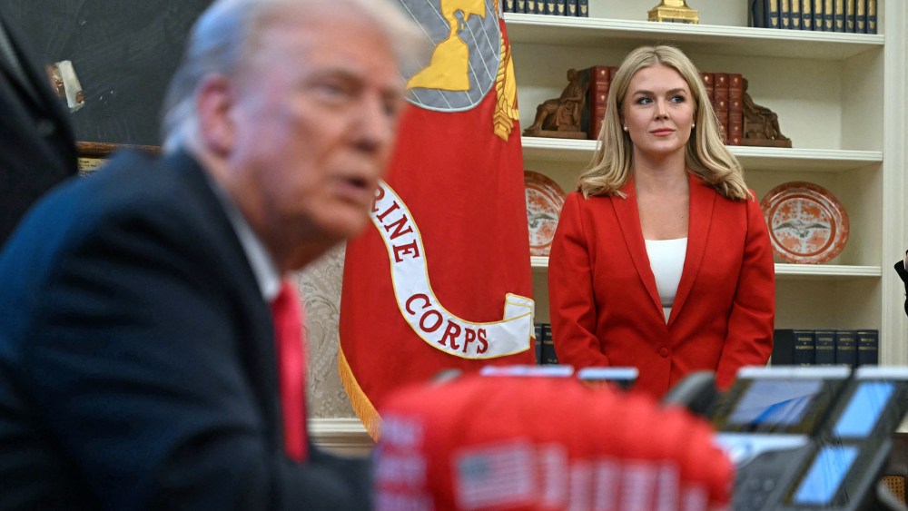 White House Press Secretary Karoline Leavitt (R) looks on as US President Donald Trump speaks to the press next to hats reading "Trump was right about everything", after signing an Executive Order at the Oval Office of the White House in Washington, DC on February 25, 2025. Trump signed an executive order on price transparency requirements on the health care industry to reinstate and strengthen them. He also signed an order on the supply of copper and foreign copper in the American market, the order charges Lutnick with looking at process to potentially impose tariffs or trade barriers.