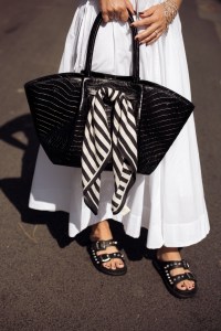 CANNES, FRANCE - MAY 17: Gili Biegun wears a long white summer maxi dress, black bag with black and white scarf and black slippers with metal details during day five of the 78th Cannes Film Festival on May 17, 2025 in Cannes, France. (Photo by Raimonda Kulikauskiene/Getty Images)