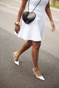 CANNES, FRANCE - MAY 17: Zufi Alexander wears white mini dress from Alaia, black heart shape bag from Alaia, white pointy shoes, big golden statement bracelet during day five of the 78th Cannes Film Festival on May 17, 2025 in Cannes, France. (Photo by Raimonda Kulikauskiene/Getty Images)