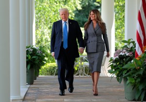 WASHINGTON, DC - MAY 19: U.S. President Donald Trump and First Lady Melania Trump arrive at the signing ceremony for the TAKE IT DOWN Act in the Rose Garden of the White House on May 19, 2025 in Washington, DC. The first lady made the Tools to Address Known Exploitation by Immobilizing Technological Deepfakes on Websites and Networks (TAKE IT DOWN) Act a priority, traveling to Capitol Hill to lobby lawmakers and show her support for the legislation, which addresses non-consensual intimate imagery, or "revenge porn," and artificial intelligence deepfakes posted online and to social media. (Photo by Chip Somodevilla/Getty Images)