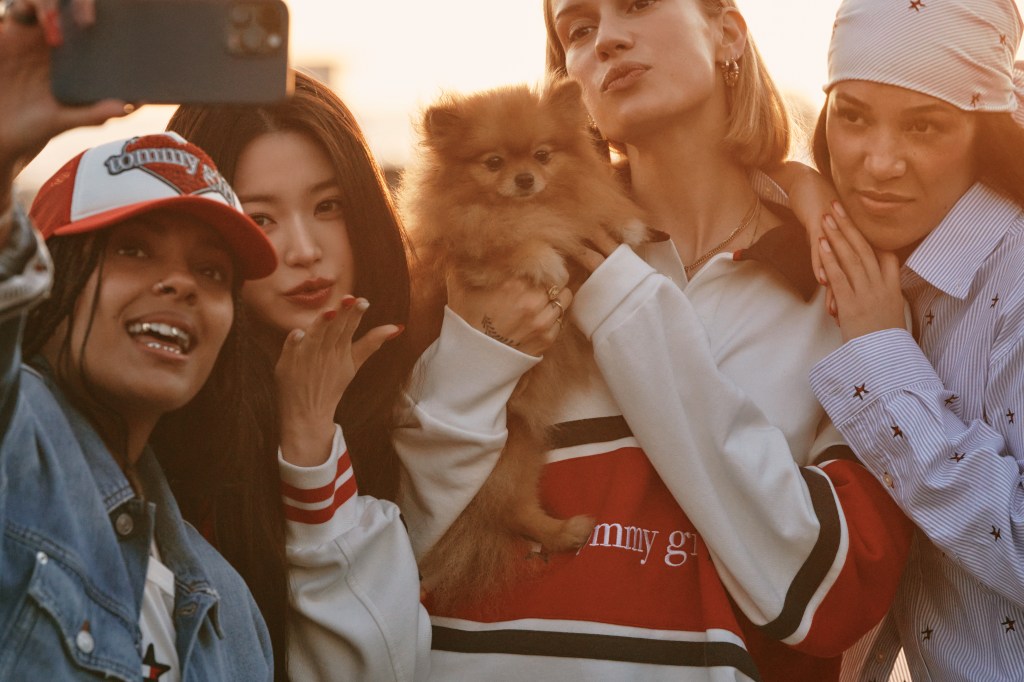 An image from Tommy Girl campaign featuring four women and a dog