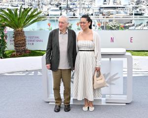 Robert De Niro, Tiffany Chen at the Honorary Palme d'Or: Robert De Niro Photocall - at 78th Cannes Film Festival held at Palais des Festivals on May 13, 2025 in Cannes, France.