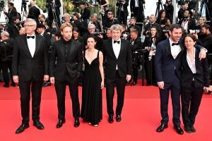 Sergei Loznitsa, Aleksandr Kuznetsov, Kevin Chneiweiss during the Closing Ceremony of the 78th Cannes Film Festival held at the Palais des Festivals on May 24, 2025 in Cannes, France.