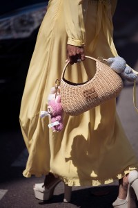CANNES, FRANCE - MAY 17: Zufi Alexander wears an all Miu Miu look made of butter yellow long summer dress, off white pumps high heels with platform and straw Miu Miu bag with attached Labubu bag charms during day five of the 78th Cannes Film Festival on May 17, 2025 in Cannes, France. (Photo by Raimonda Kulikauskiene/Getty Images)