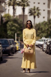 CANNES, FRANCE - MAY 17: Zufi Alexander wears an all Miu Miu look made of butter yellow long summer dress, off white pumps high heels with platform, sunglasses and straw Miu Miu bag with attached Labubu bag charms during day five of the 78th Cannes Film Festival on May 17, 2025 in Cannes, France. (Photo by Raimonda Kulikauskiene/Getty Images)