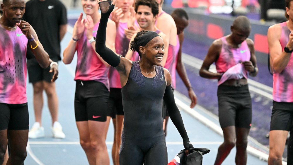 Kenya's Faith Kipyegon reacts at the end of her race after taking part in the "Breaking4" event, in an attempt to become the first woman to run a mile in under four minutes, at Stade Charlety on June 26, 2025 in Paris. Triple Olympic champion Faith Kipyegon of Kenya fell well short in her bid to become the first woman to run a sub-four minute mile on June 26. Aided by wavelength technology and 13 pacers, 11 male and two women, Kipyegon clocked 4min 06.42sec over 1.6km in perfect conditions.