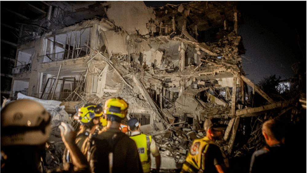 Israeli home front command soldiers look at a building that was hit in an Iranian ballistic missile strike in Ramat Gan on June 14, 2025.