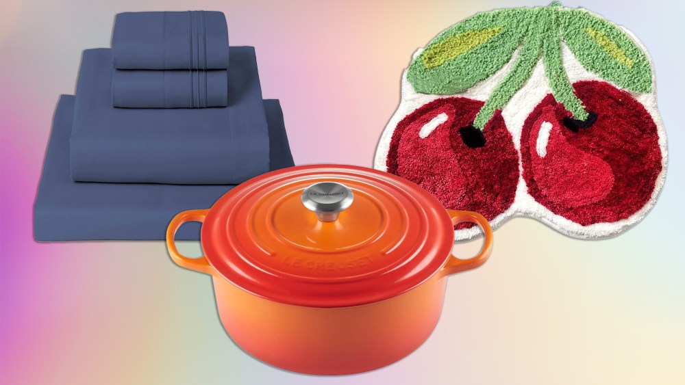 a bedding set, cherry-themed bath rug, and orange le creuset dutch oven over a light holographic background