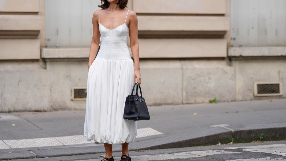 a woman wearing a white drop-waist summer dress