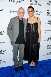 Robert De Niro, Tiffany Chen at the "Billy Joel: And So It Goes" world premiere at the Tribeca Festival opening night held at Beacon Theatre on June 04, 2025 in New York, New York.