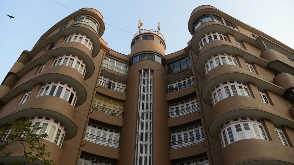 This photo taken on November 8, 2017 shows an Art Deco building in Mumbai.
The seafront is lined with brightly coloured buildings boasting curved corners, stylish balconies and exotic motifs but this isn't Miami's famous Art Deco district -- it's Mumbai. Bombay, as the Indian city was formerly called, is known more for its Victorian Gothic edifices than the sleeker architectural designs that swept Europe and America during the 1920s and '30s.
 / AFP PHOTO / PUNIT PARANJPE / To go with: 'INDIA-ARCHITECTURE-HERITAGE-ARTDECO, FEATURE' by Peter HUTCHISON        (Photo credit should read PUNIT PARANJPE/AFP via Getty Images)