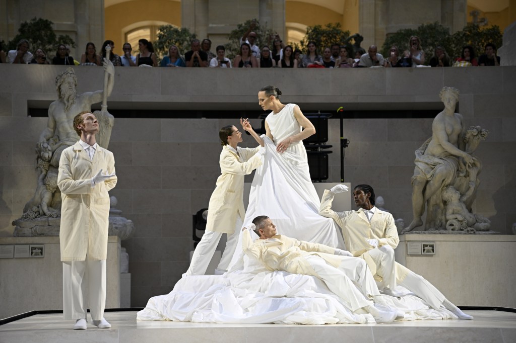 Jordan Roth gives a fashion performance at the Louvre during Paris Couture Week.