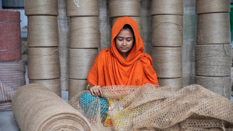 A worker prepares jute bags used to transport rice, onions and potatoes in a factory in Ashulia, Bangladesh.