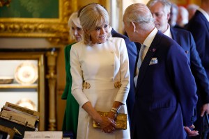 WINDSOR, ENGLAND - JULY 8: France's President Emmanuel Macron's wife Brigitte Macron talks to Britain's King Charles III view an exhibition of art from the Royal Collection exhibition, in the Green Drawing Room at Windsor Castle on July 8, 2025 in Windsor, England. President Emmanuel Macron and Mrs Brigitte Macron visit the UK in the first visit State Visit made by France in 17 years. They are staying at Windsor Castle, hosted by King Charles III and Queen Camilla, and a banquet will be held there in their honour. The Macrons will visit Imperial College, and the President will address Parliament during his stay.  (Photo by Benjamin Cremel - WPA Pool/Getty Images)