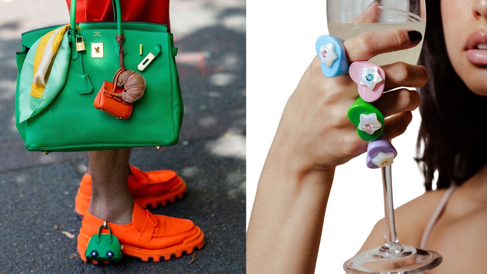 a street style image of an hermes bag with bag charms and playful puffy heart rings