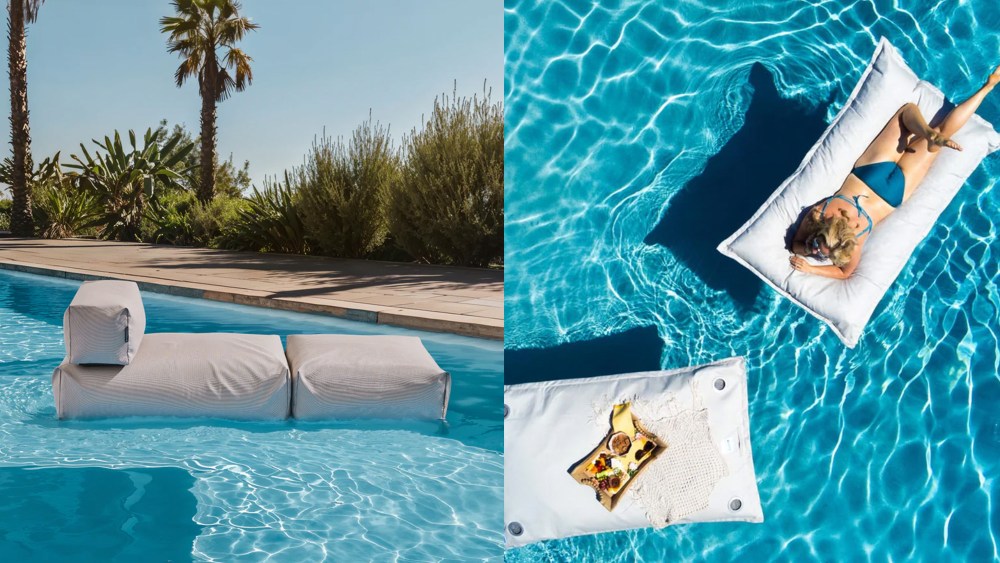 pool lounger in swimming pool surrounded by palm trees; woman floating on pool pillow, shot from a bird's eye angle