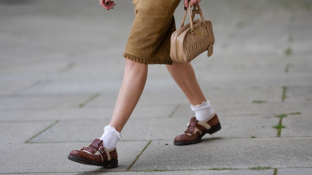 street style photo of a woman wearing ruffle socks and loafers