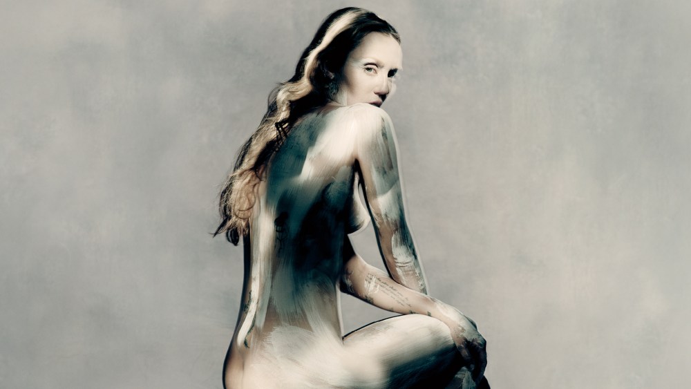 Miley Cyrus wearing white body paint in the Maison Margiela autumn-winter campaign.