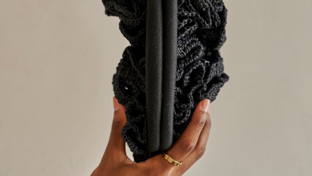 The crocheted rose clutch is handcrafted by Syrian refugee