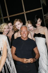 Fashion designer Giorgio Armani (center) and models backstage at Armani's Giorgio Armani Prive fall 2008 haute couture show at the Palais de Chaillot in Paris.